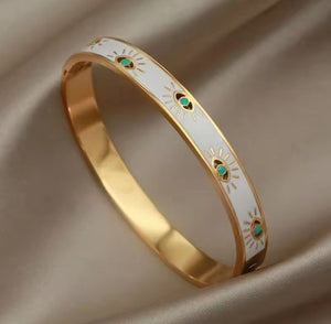 PULSERA OJOS BLANCA DORADA