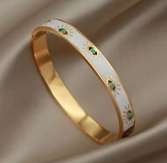 PULSERA OJOS BLANCA DORADA